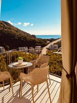 a balcony with chairs and a table with a view at Most Oliva Resort Budva in Budva