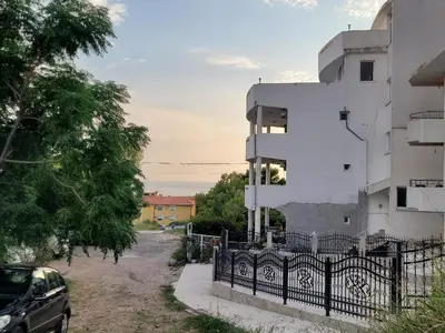 a car parked next to a white building at Montenegro Apartments Phoenix With Pool in Bar