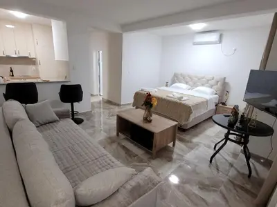 a living room with a couch and a bed at Montenegro Apartments Phoenix With Pool in Bar