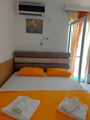 a bedroom with a bed with two towels on it at Helen's apartments in Budva