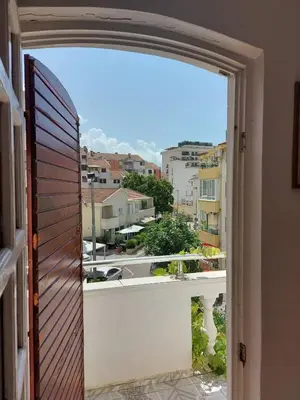 an open window with a view of a city at Helen's apartments in Budva