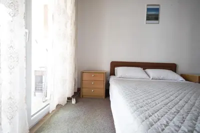 a bedroom with a bed and a window at Status-M Apartments Irysh in Becici