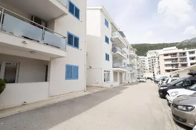 a street with cars parked in a parking lot at Status-M Apartments Irysh in Becici