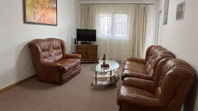 a living room with two leather chairs and a table at Status-M Apartments Irysh in Becici