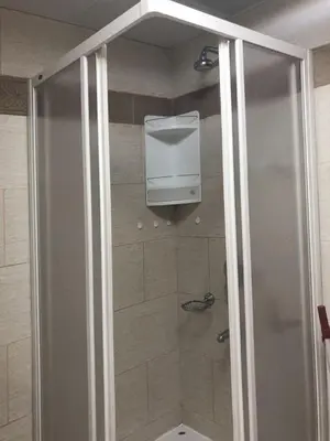 a bathroom with a shower with a toilet in it at Status-M Apartments Irysh in Becici