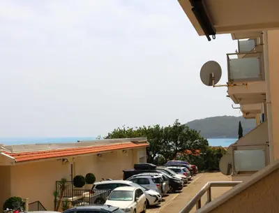 a row of cars parked in a parking lot at Status-M Apartments Irysh in Becici