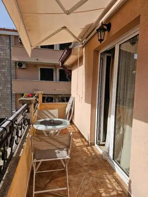 a patio with a table and chairs on a balcony at Apartments Carpe Diem in Kotor