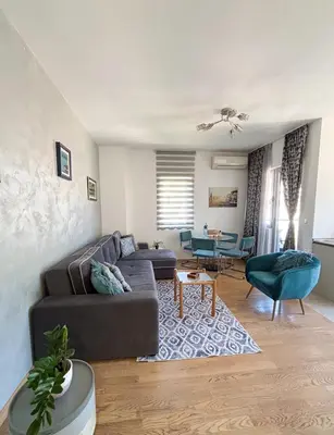 a living room with a couch and a table at Charming Stay in Budva Center with Parking in Budva