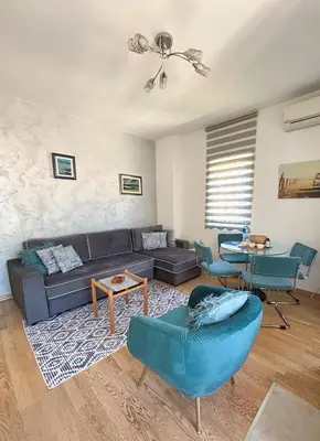 a living room with a couch and a table at Charming Stay in Budva Center with Parking in Budva