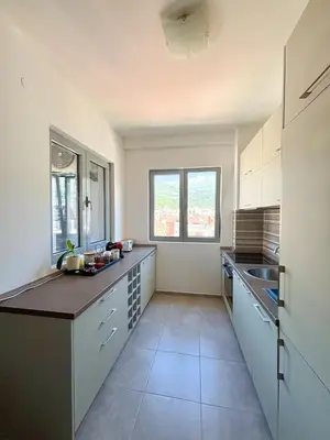 a kitchen with white cabinets and a counter top at Charming Stay in Budva Center with Parking in Budva