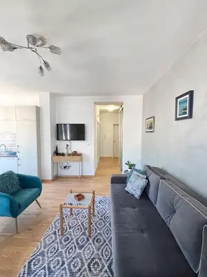 a living room with a couch and a table at Charming Stay in Budva Center with Parking in Budva