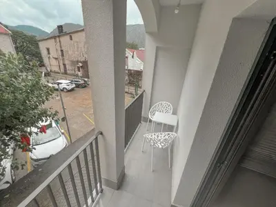 a balcony with a chair and a view of a street at Absolute Adriatic in Kotor