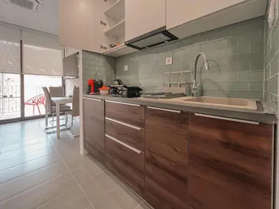 a kitchen with wooden cabinets and a sink at Absolute Adriatic in Kotor
