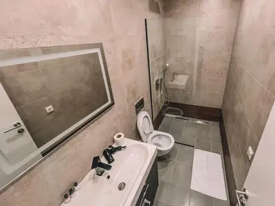 a bathroom with a sink and a toilet and a mirror at Absolute Adriatic in Kotor