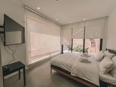 a bedroom with a bed and a large window at Absolute Adriatic in Kotor