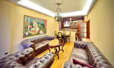 a living room with leather couches and a table at Heart of the City Stunning comfort,Balcony ,Netflix,Free Wi-Fi in Podgorica