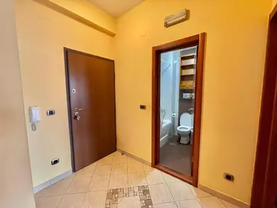 an empty bathroom with a toilet and a door at Heart of the City Stunning comfort,Balcony ,Netflix,Free Wi-Fi in Podgorica