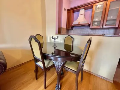 a dining room table with two chairs and a mirror at Heart of the City Stunning comfort,Balcony ,Netflix,Free Wi-Fi in Podgorica