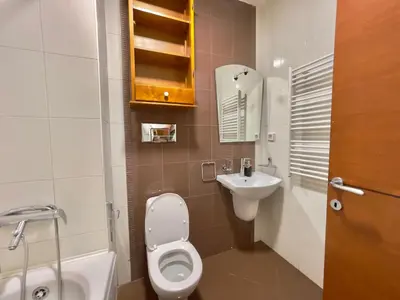 a small bathroom with a toilet and a sink at Heart of the City Stunning comfort,Balcony ,Netflix,Free Wi-Fi in Podgorica
