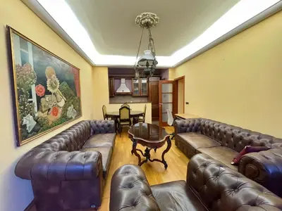 a living room with leather couches and a table at Heart of the City Stunning comfort,Balcony ,Netflix,Free Wi-Fi in Podgorica