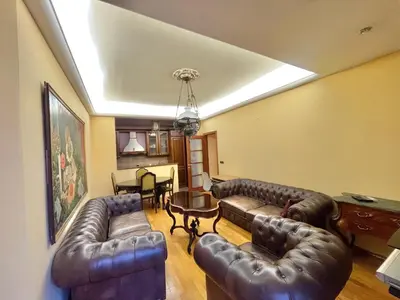 a living room with leather couches and a table at Heart of the City Stunning comfort,Balcony ,Netflix,Free Wi-Fi in Podgorica