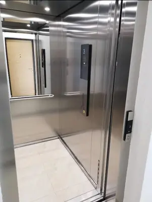 a stainless steel refrigerator with a window in a room at Comfort Residence Art Zone in Podgorica