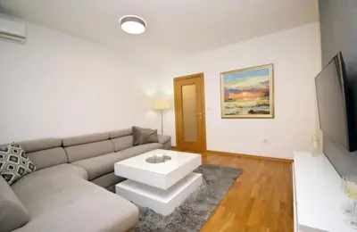 a living room with a couch and a table at Comfort Residence Art Zone in Podgorica