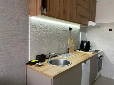 a kitchen with a sink and a counter top at Original Sunny place in Podgorica
