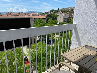 a balcony with a bench and a view of a city at Original Sunny place in Podgorica