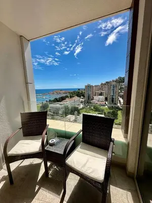 a balcony with two chairs and a view of the ocean at Apartman Drobnjak Center-sea View in Budva