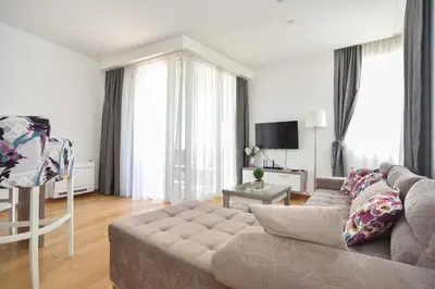 a living room with a couch and a television at Apartman Drobnjak Center-sea View in Budva