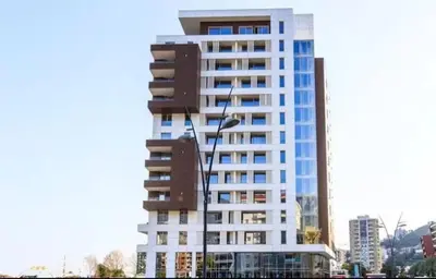 a tall building with a street light in front of it at Apartman Drobnjak Center-sea View in Budva