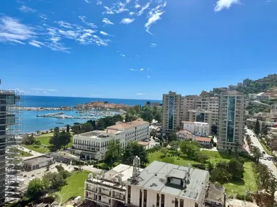 an aerial view of a city with buildings and the ocean at Apartman Drobnjak Center-sea View in Budva