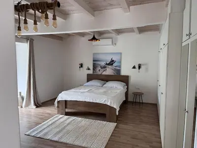a bedroom with a bed and a painting on the wall at Sailors Home Stari Bar in Bar