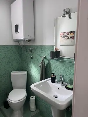 a bathroom with a white toilet and a sink at Sailors Home Stari Bar in Bar