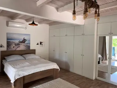 a bedroom with white cabinets and a large bed at Sailors Home Stari Bar in Bar