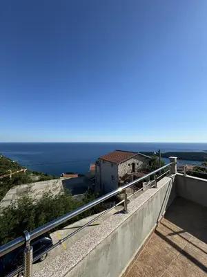 a view of the ocean from the balcony of a house at Villa Happy Family!!! in Prijevor