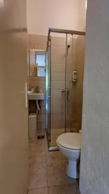 a bathroom with a toilet and a shower and a sink at Star Apartment in Cetinje