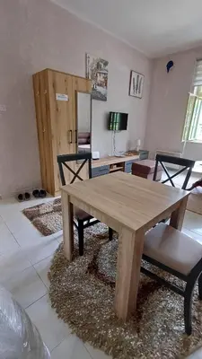 a wooden table and chairs in a living room at Star Apartment in Cetinje