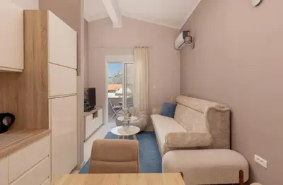 a living room with a couch and a chair at Sapphire view apartment in Kotor