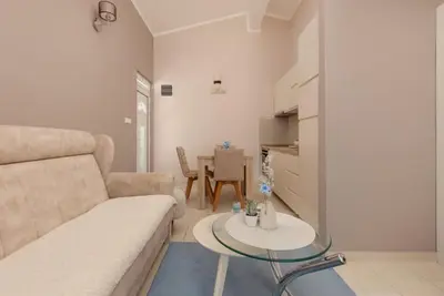 a living room with a couch and a table at Sapphire view apartment in Kotor