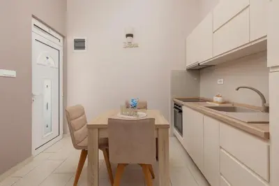 a kitchen with a small table and a sink at Sapphire view apartment in Kotor