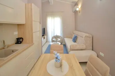 a small living room with a couch and a table at Sapphire view apartment in Kotor