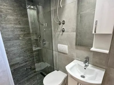 a bathroom with a shower and a toilet and a sink at Sea Star in Bar