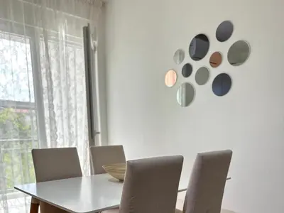 a dining room with a white table and chairs at Sea Star in Bar