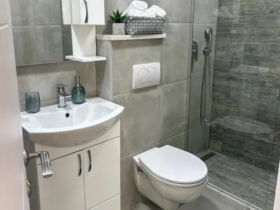 a bathroom with a toilet and a sink and a shower at Sea Star in Bar