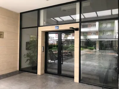 an entrance to a building with glass doors at Apartments Central Point 11 & Private Garage in Podgorica