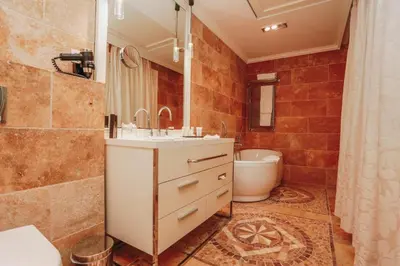 a bathroom with a sink and a toilet and a tub at The Unique Splendid Conference Spa Resort Family apt suite sleeps 6 in Becici