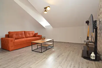 a living room with a couch and a table at MD Residence in Kotor