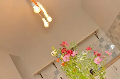 a vase filled with flowers in a room at MD Residence in Kotor